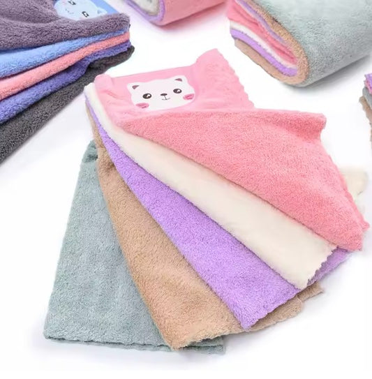 Stack of folded towels in various colors with a cat face design on a white background