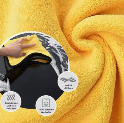 Yellow towel with a hand holding it, featuring text about its properties.