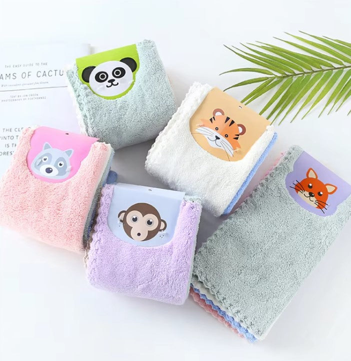 Set of colorful baby towels with animal face designs on a white surface.
