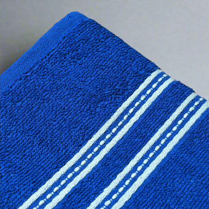 Blue towel with white stripes on a wooden surface