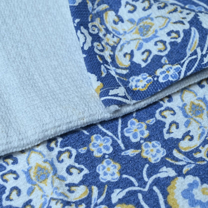 Close-up of blue floral fabric with light blue background