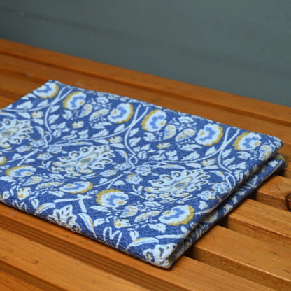 Blue floral-patterned towel on a wooden surface
