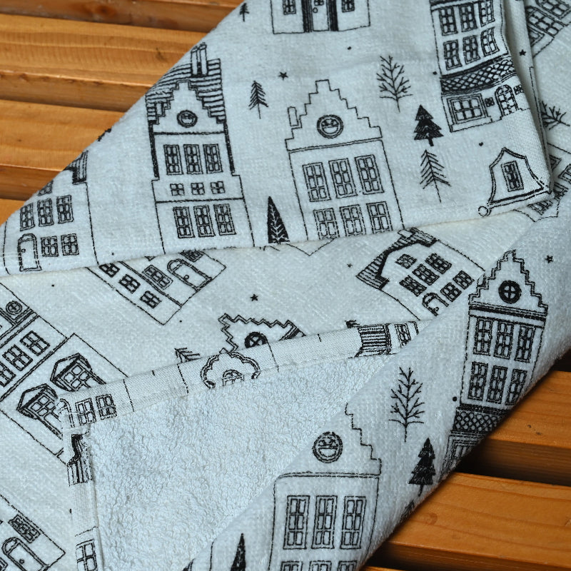 Fabric with house pattern on a wooden surface