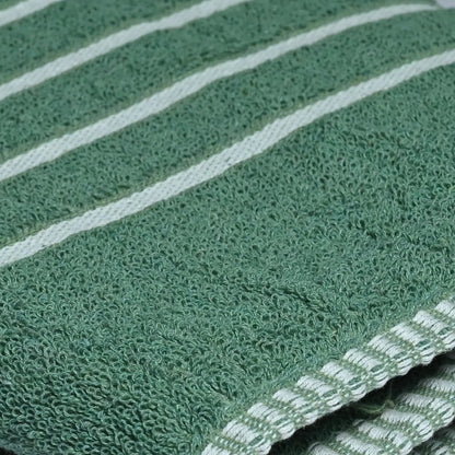 Green towel with white stripes on a white surface