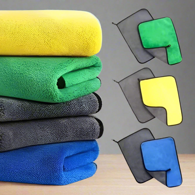 Stack of colorful microfiber towels with additional towels displayed separately on a grey background.
