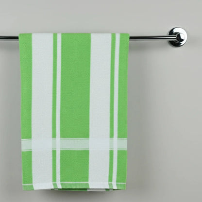 Green and white plaid towel hanging on a silver towel rack against a gray background