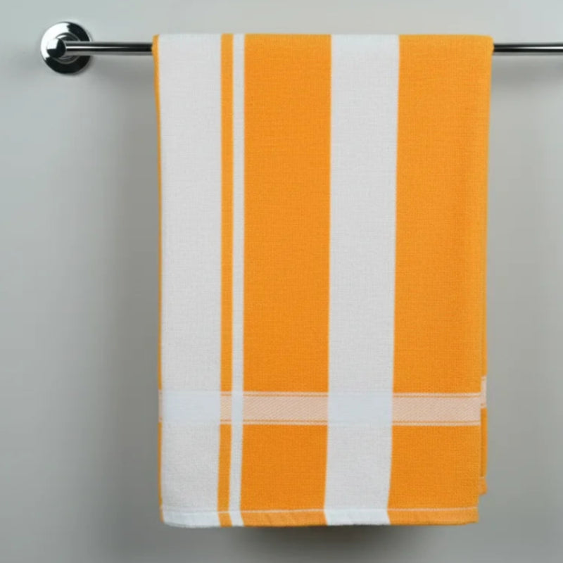 Yellow and white striped towel hanging on a silver towel rack against a gray background
