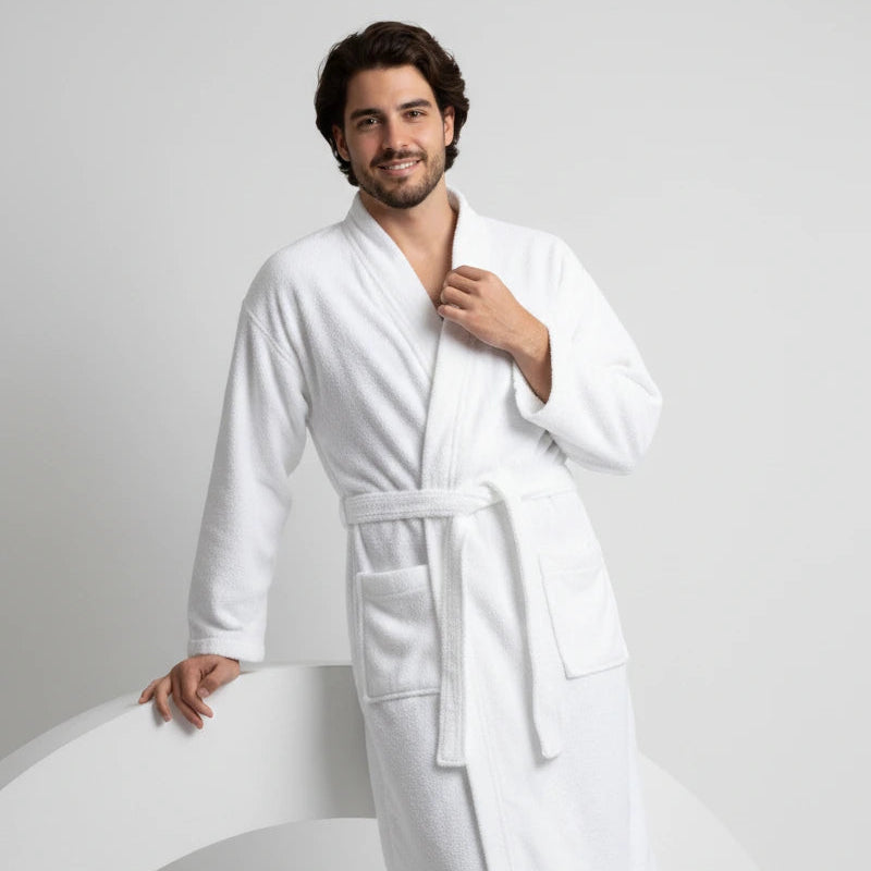 Man wearing a white robe against a plain background