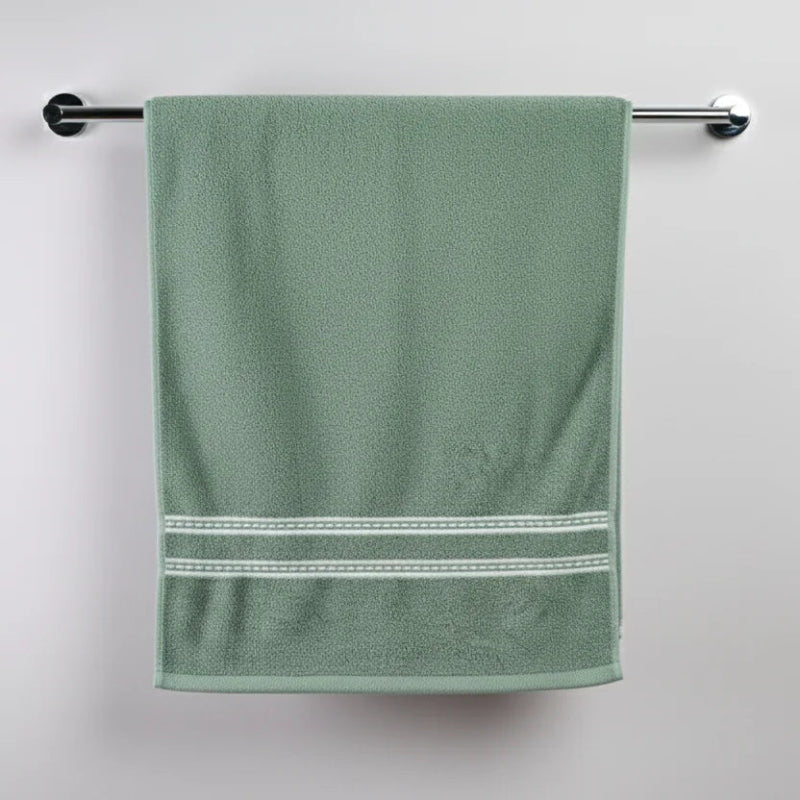 Green towel with white trim hanging on a towel rack against a white background