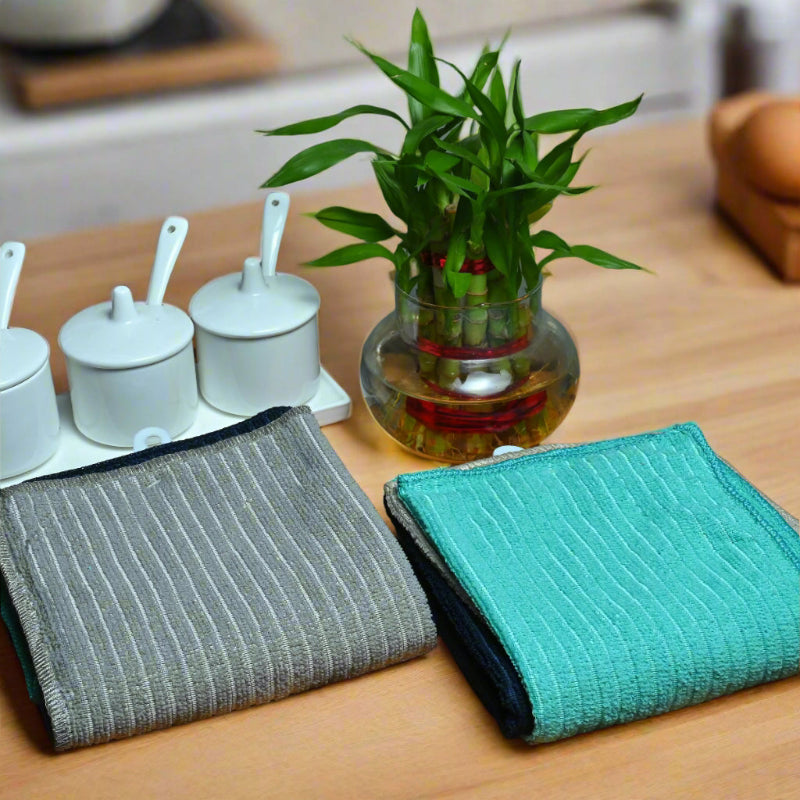 2 set of cleaning towel placed over a wooden surface with crockey and plant in glass jar.