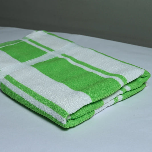 Folded green and white checkered towel on a light surface