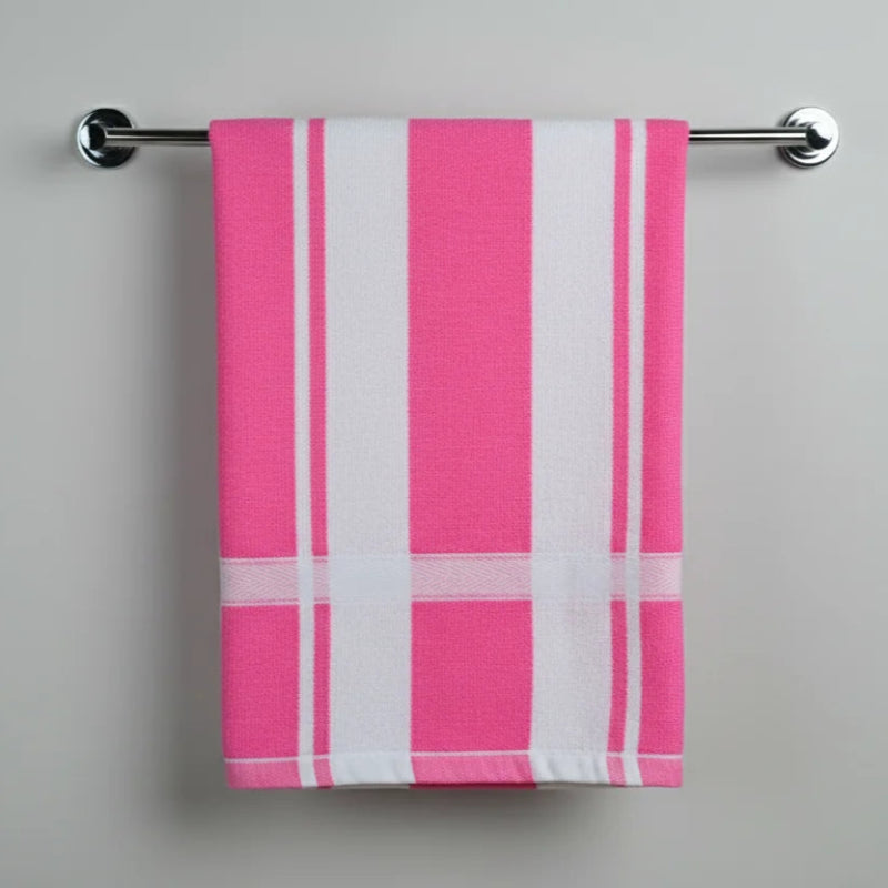 Pink and white striped towel hanging on a silver towel rack against a gray background