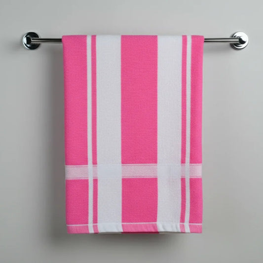 Pink and white striped towel hanging on a silver towel rack against a gray background
