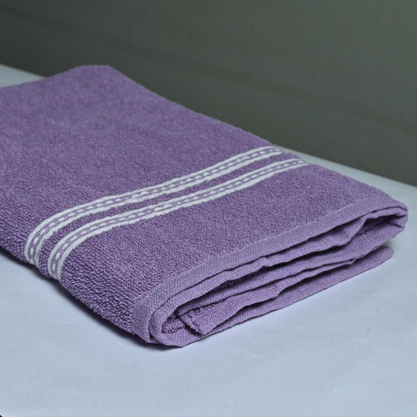 Folded purple towel with white stripes on a white surface