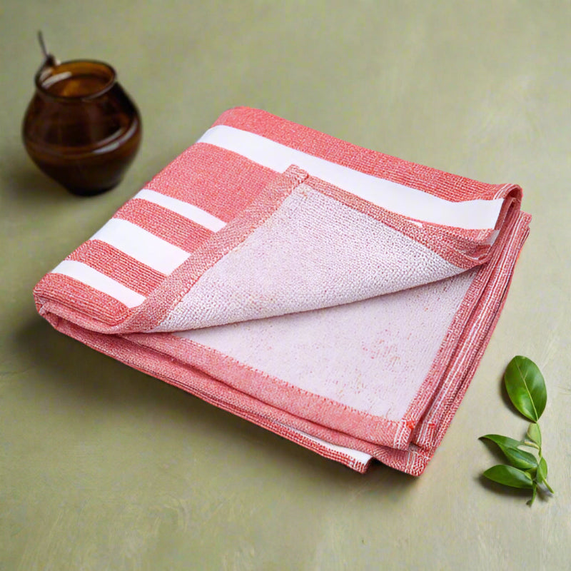 Folded red and white striped towel on a light gray background