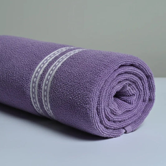 Rolled purple towel with a white stripe on a light gray background