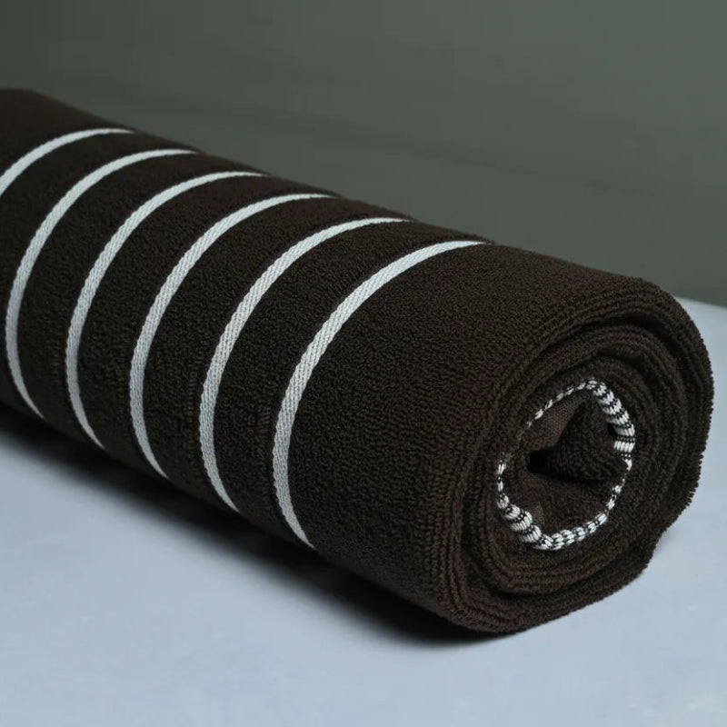 Roll of brown fabric with white stripes on a gray background