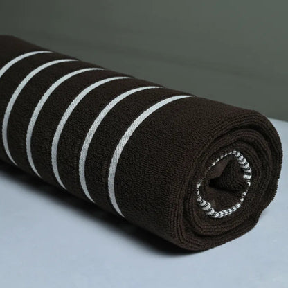 Roll of brown fabric with white stripes on a gray background