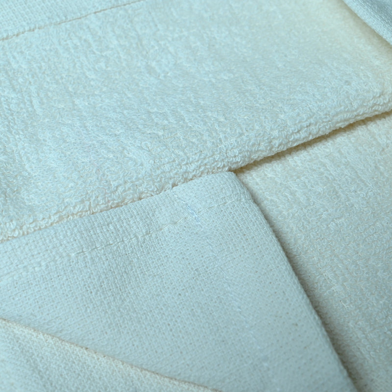 Close-up of a white quilted fabric surface