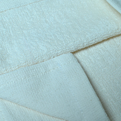 Close-up of a white quilted fabric surface