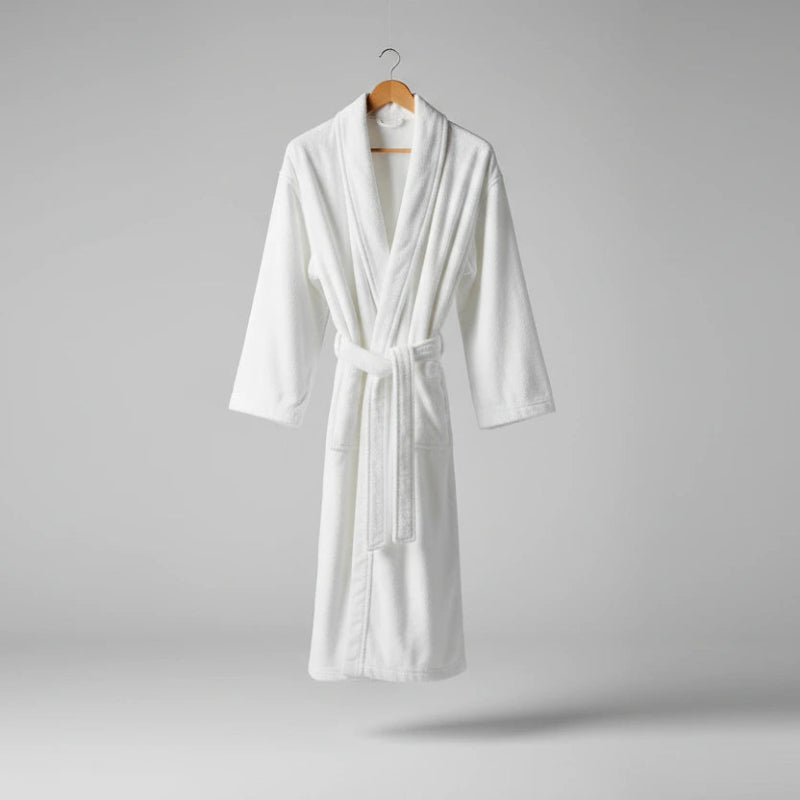 White bathrobe on a hanger against a gray background