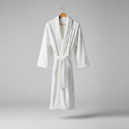 White bathrobe on a hanger against a gray background