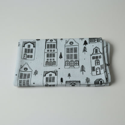 Folded fabric with house pattern on a white surface