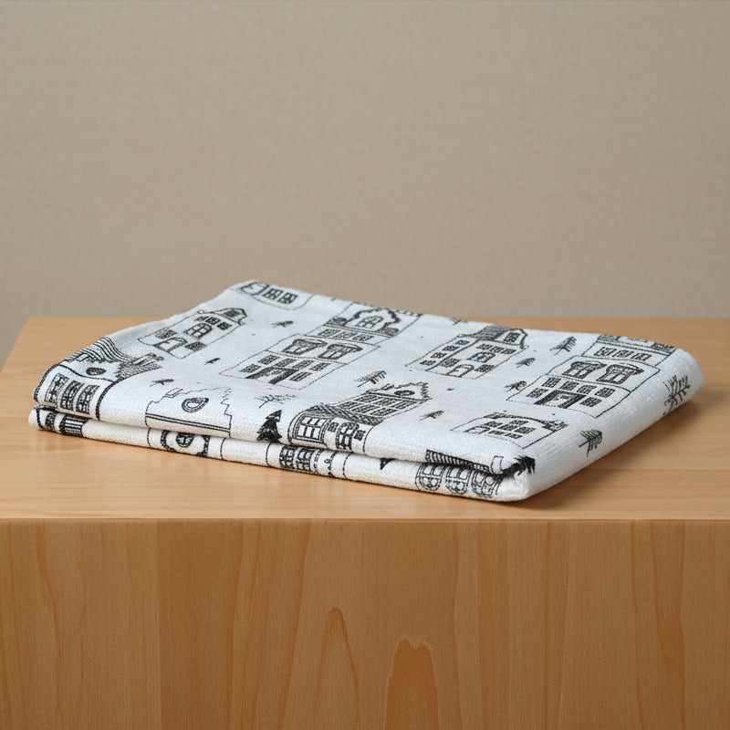 Folded fabric with black and white pattern on a wooden surface
