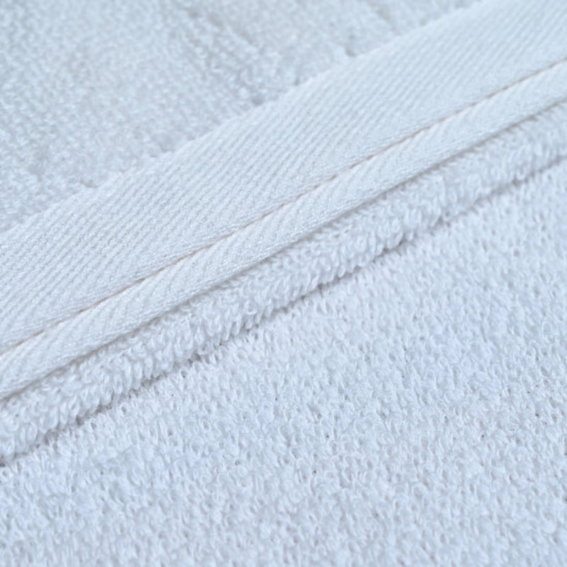 Close-up of white towel fabric texture with visible stitching