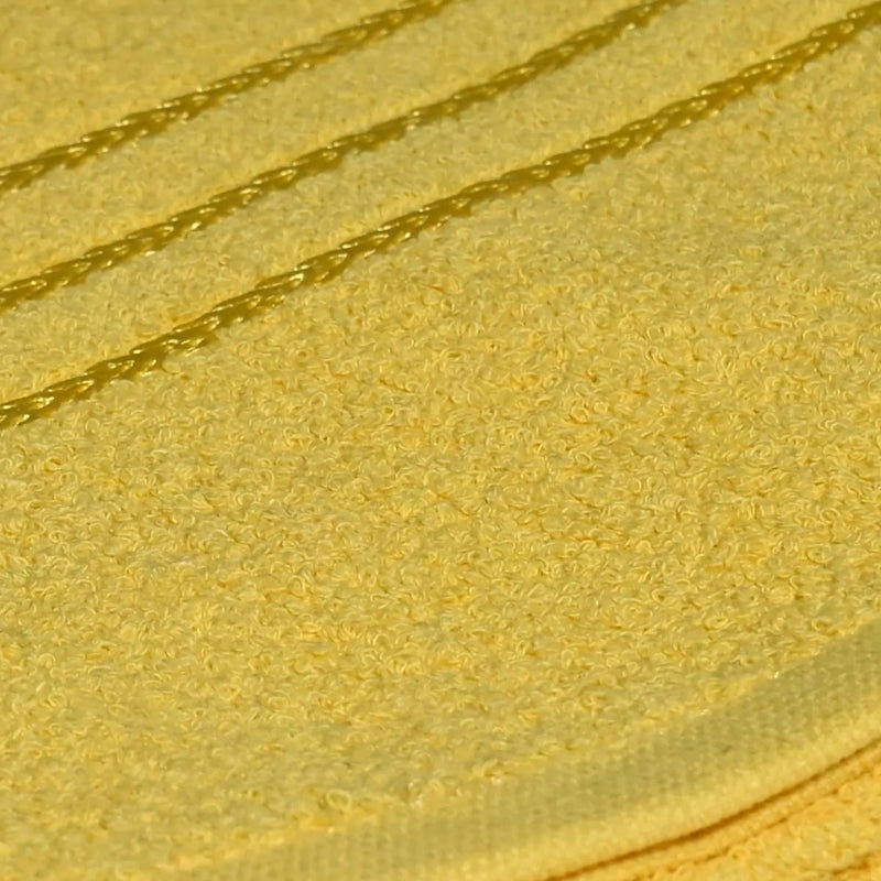 Yellow towel fabric closeup on a white surface with a blurred background