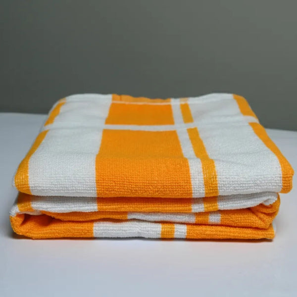 Stack of orange and white checkered towels on a gray background