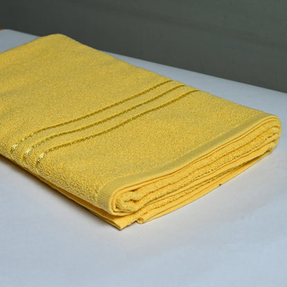 Yellow towel on a white surface with a blurred background