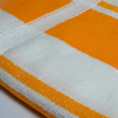 Close-up of a fabric with orange and white stripes on a white background